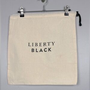Liberty Black ivory drawstring dustbag, approximately 15” x 15.5”.
